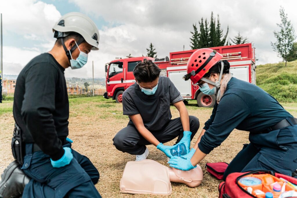 Man practicing CPR on a dummy during a class
